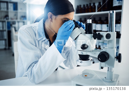 Woman, scientist and microscope, study and analysis, check DNA sample and science experiment in laboratory. Female doctor analyze data, scientific innovation and medical research with knowledge 135170138
