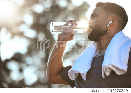 Man, fitness and drinking water in nature for sustainability, hydration or break after running workout or exercise. Male person or runner with natural drink for healthy wellness or rest from run Man, fitness and drinking water in nature for sustainability, hydration or break after running workout or exercise. Male person or runner with natural drink for healthy wellness or rest from run 135170240