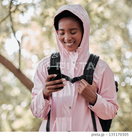 Black woman, phone and smile for hiking communication, social media or chatting in nature. Happy African female person or hiker smiling on mobile smartphone for trekking, travel or online location 135170305