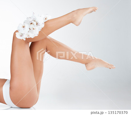 Woman in underwear, legs and body with flowers, hair removal for skincare and wellness on white background. Female model, natural cosmetics and epilation with organic product for grooming and hygiene 135170370