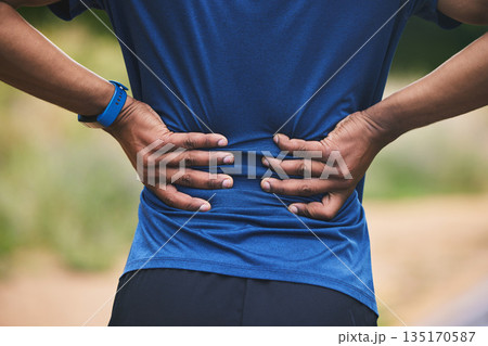 Back pain, fitness and hands of man in park after workout, exercise and training or running outdoors. Medical emergency, health and closeup of male person with muscle strain, injury or hurt in nature Back pain, fitness and hands of man in park after workout, exercise and training or running outdoors. Medical emergency, health and closeup of male person with muscle strain, injury or hurt in nature 135170587
