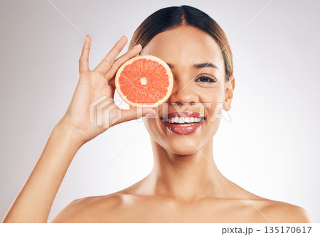 Grapefruit, skincare and woman smile in studio for natural cosmetic, eco or beauty on grey background. Citrus, facial and female model relax with fruit for vegan, detox and vitamin c for glowing skin Grapefruit, skincare and woman smile in studio for natural cosmetic, eco or beauty on grey background. Citrus, facial and female model relax with fruit for vegan, detox and vitamin c for glowing skin 135170617