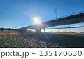 夕日に照らされる橋と橋の下の河口 135170630