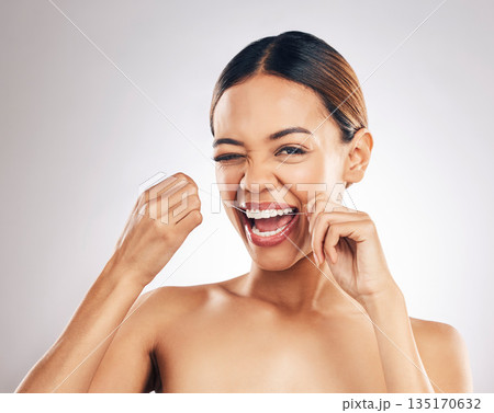 Dental, portrait and happy woman flossing teeth in studio for hygiene, wellness and fresh breath on grey background. Face, floss and female relax with mouth, tooth and cleaning for oral care routine 135170632