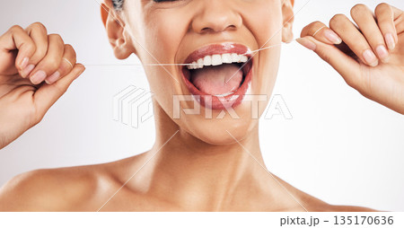 Smile, dental and woman flossing teeth in studio for hygiene, wellness or fresh breath on grey background. Hands, floss and lady relax with mouth, tooth or cleaning for oral care or cavity prevention 135170636
