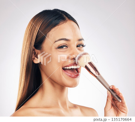 Makeup brush, portrait and excited woman in studio with a natural, cosmetic and luxury face routine. Glamour, cosmetology and female model with beauty product for cheeks isolated by white background. Makeup brush, portrait and excited woman in studio with a natural, cosmetic and luxury face routine. Glamour, cosmetology and female model with beauty product for cheeks isolated by white background. 135170664