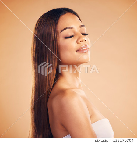 Beauty, hair and face of woman for wellness, keratin treatment and cosmetics in studio. Salon, hairdresser and female person with eyes closed on orange background for growth, hairstyle and texture 135170704