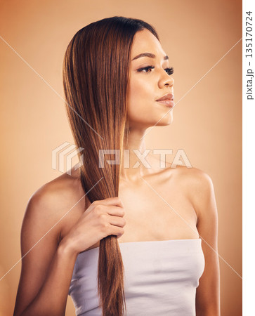 Woman, hair and beauty with salon hairstyle, haircare and keratin treatment isolated on brown studio background. Female model with highlights, color and cosmetic care, texture and growth with shine Woman, hair and beauty with salon hairstyle, haircare and keratin treatment isolated on brown studio background. Female model with highlights, color and cosmetic care, texture and growth with shine 135170724