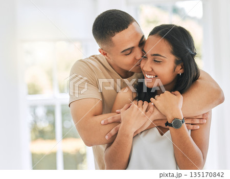 Couple, hug and kiss in home for love, care and relax for romance, support and trust of bonding together. Happy man hugging young woman, partner and kissing for quality time, happiness or anniversary Couple, hug and kiss in home for love, care and relax for romance, support and trust of bonding together. Happy man hugging young woman, partner and kissing for quality time, happiness or anniversary 135170842