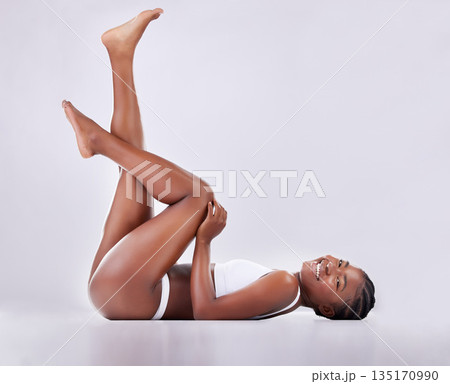 Beauty, legs and portrait of black woman on studio floor for shaving, hair grooming and wellness. Skincare, underwear and female person on white background for cosmetics, natural skin or body care 135170990