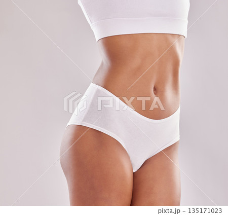 Stomach, wellness and woman body in underwear in studio for diet, positivity and self love on grey background. Detox, beauty and female model with slim, tummy or bodycare in lingerie with confidence Stomach, wellness and woman body in underwear in studio for diet, positivity and self love on grey background. Detox, beauty and female model with slim, tummy or bodycare in lingerie with confidence 135171023