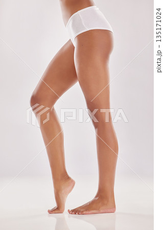 Woman in underwear, legs and beauty with hair removal and natural cosmetics isolated on studio background. Body, skincare and female model, dermatology and self care with epilation and treatment 135171024