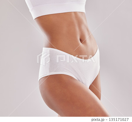 Body, care and woman in underwear in studio for diet, wellness and self love on grey background. Detox, beauty and female model with slim, stomach or bodycare in lingerie posing with confidence 135171027