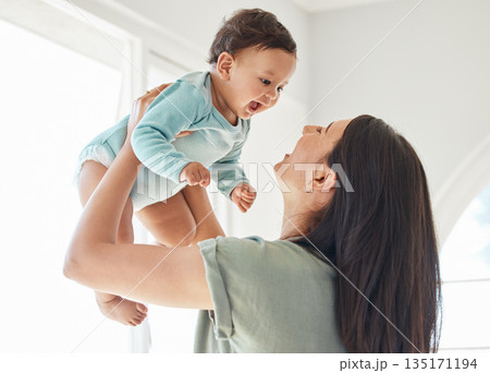Mother holding laughing baby in home for love, care and quality time together to nurture childhood development. Happy mom, carrying and playing with infant girl kid for support, happiness and fun Mother holding laughing baby in home for love, care and quality time together to nurture childhood development. Happy mom, carrying and playing with infant girl kid for support, happiness and fun 135171194