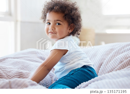 Happy portrait, girl and kid in bedroom for fun, childhood development and baby growth with curly hair. Cute, adorable and sweet toddler, young child or relaxing on comfortable bed in nursery at home Happy portrait, girl and kid in bedroom for fun, childhood development and baby growth with curly hair. Cute, adorable and sweet toddler, young child or relaxing on comfortable bed in nursery at home 135171195