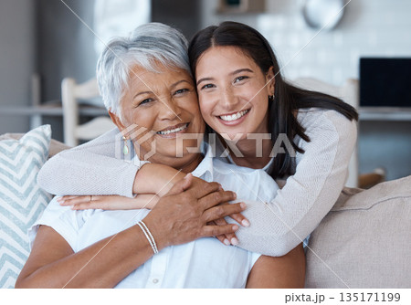 Hug, mothers day and portrait of women smile for care, trust and support on a sofa or couch in a home together. Happiness, love and elderly mother and daughter relax in a living room or lounge Hug, mothers day and portrait of women smile for care, trust and support on a sofa or couch in a home together. Happiness, love and elderly mother and daughter relax in a living room or lounge 135171199