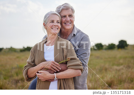 Love, hug and happy with old couple in nature for bonding, smile and romance. Happiness, retirement and support with senior man and woman in countryside for affectionate, holiday and vacation 135171318