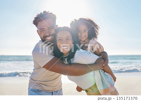 Beach, vacation and portrait of a happy family with a child excited for a sea or ocean holiday together in happiness. Water, father and young mother playing piggyback with a kid on a summer trip 135171370