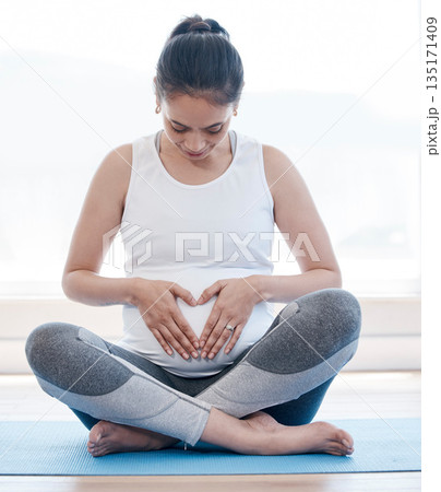 Yoga, pregnancy and hands on stomach for woman, relax or health on floor for peace, future or mindset. Girl, pregnant pilates and zen meditation for mindfulness, hope or faith in gym, studio or house 135171409