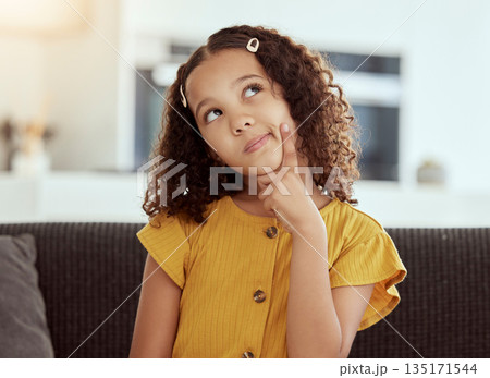 Thinking, young girl and home with ideas and inspiration on a living room sofa. Cute, decision and child with an idea and option consideration on a lounge couch in a house with youth and weekend plan 135171544