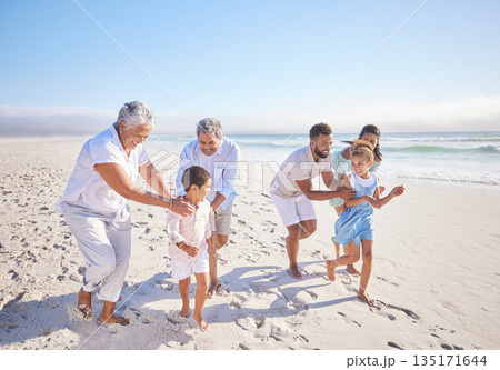 Travel, holiday and big family playing on beach for running and bonding on weekend trip. Happy, excited and children having fun with their grandparents and parents by the ocean on tropical vacation. 135171644