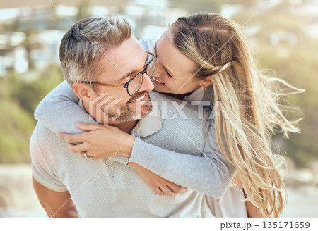 Hug, love and couple with a smile, beach or romance with relationship, marriage or summer vacation. Romantic, mature man or woman embrace, seaside holiday or bonding with happiness or loving together Hug, love and couple with a smile, beach or romance with relationship, marriage or summer vacation. Romantic, mature man or woman embrace, seaside holiday or bonding with happiness or loving together 135171659