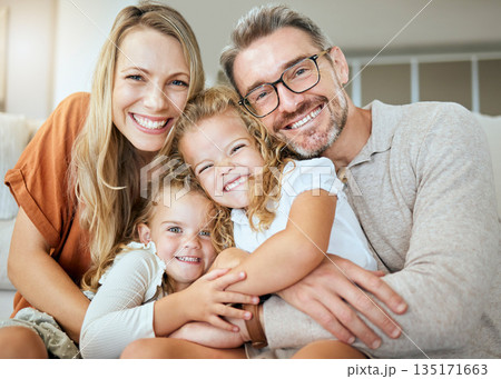 Parents, portrait and sofa with hug, kids and smile with love, bonding and care in family home together. Father, mother and daughters with happiness, embrace and relax on lounge couch in house 135171663