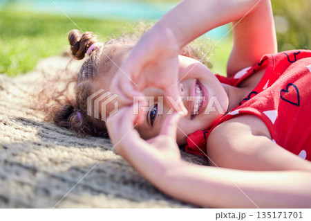 Portrait, smile and girl with a heart shape, outdoor and sunshine with happiness, carefree and relax. Face, female child and kid with symbol for love, freedom and cheerful with a young person and joy Portrait, smile and girl with a heart shape, outdoor and sunshine with happiness, carefree and relax. Face, female child and kid with symbol for love, freedom and cheerful with a young person and joy 135171701
