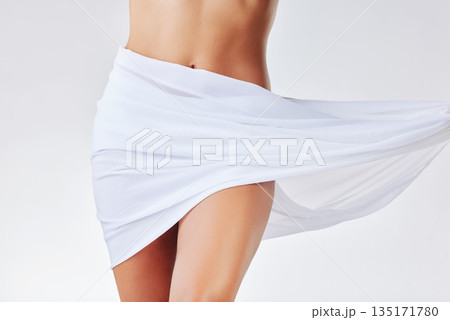 Closeup, fabric and woman with skincare, stomach and lady isolated against a white studio background. Zoom, female person and model with material, cover and dermatology with cosmetics and belly Closeup, fabric and woman with skincare, stomach and lady isolated against a white studio background. Zoom, female person and model with material, cover and dermatology with cosmetics and belly 135171780
