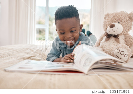Young african boy, reading and bed for story, book and learning with smile in family home, focus and excited. Black male child, education and relax in bedroom with happiness, study or comic in house Young african boy, reading and bed for story, book and learning with smile in family home, focus and excited. Black male child, education and relax in bedroom with happiness, study or comic in house 135171991