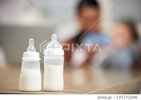 Baby bottle, milk and parent with child for healthcare, wellness or home love with product on living room table. Growth, development and liquid, food or drink for infant or newborn kid, mom or person Baby bottle, milk and parent with child for healthcare, wellness or home love with product on living room table. Growth, development and liquid, food or drink for infant or newborn kid, mom or person 135172046