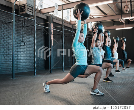 Fitness, group and medicine ball for lunges exercise at a gym with diversity, energy and motivation. Strong men and women friends or people together for a sports class, training and wellness workout 135172057