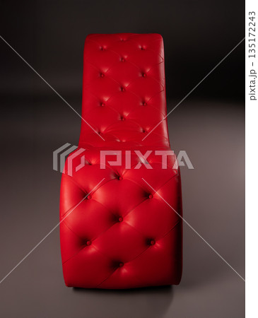 Elegant red tufted leather chair isolated on a dark gray studio background. Elegant red tufted leather chair isolated on a dark gray studio background. 135172243