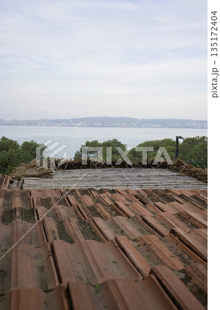 Rustic brown tile roof and sea view Rustic brown tile roof and sea view 135172404