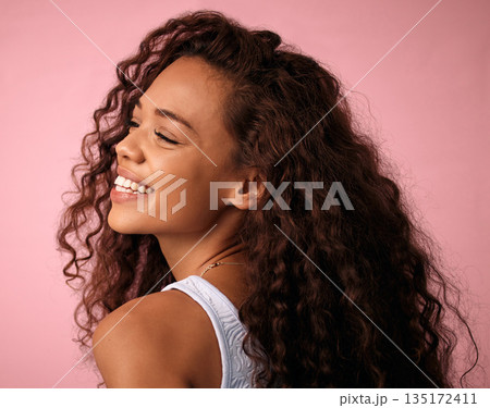 Beauty, hair care and young woman in a studio with a natural, long and curly hairstyle. Happy, smile and profile of a brunette female model with a keratin salon treatment isolated by pink background. 135172411