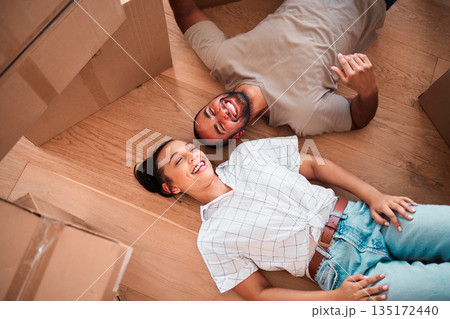 Top view, happy couple and moving into new home on floor, ground and relax from packing boxes. Man, woman and taking a break in house from property mortgage, real estate and investment of apartment 135172440