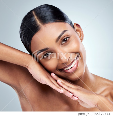 Happy, skincare and portrait of Indian woman with beauty cosmetic isolated in a studio white background. Clean, natural and female person or model hand on her face for self love, dermatology or care 135172553