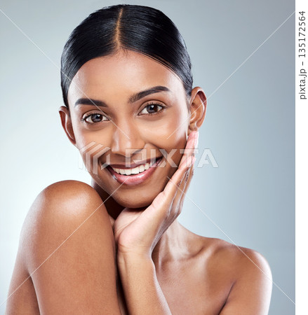 Smile, portrait and Indian woman beauty or model with skincare cosmetic isolated in a studio white background. Clean, natural and female person hand on face happy for self love, care or dermatology Smile, portrait and Indian woman beauty or model with skincare cosmetic isolated in a studio white background. Clean, natural and female person hand on face happy for self love, care or dermatology 135172564