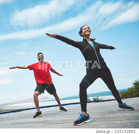 Fitness, health and couple doing outdoor pilates stretching together for body balance exercise. Happy, smile and young man and woman doing a yoga warm up workout or challenge for health in nature. Fitness, health and couple doing outdoor pilates stretching together for body balance exercise. Happy, smile and young man and woman doing a yoga warm up workout or challenge for health in nature. 135172691