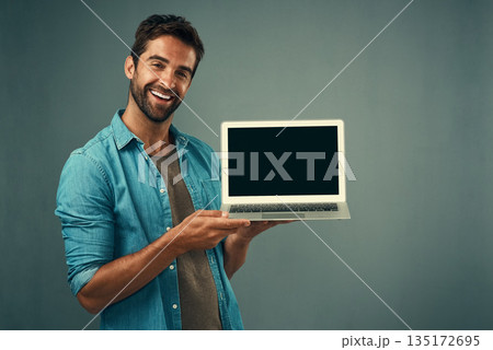 Happy man, laptop and mockup screen for advertising or marketing against a grey studio background. Portrait of male person with smile showing computer display or copy space for branding advertisement 135172695