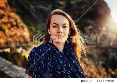 Portrait, young woman and relax outdoors or tourist for vacation in summer or europe fresh air in nature and on mountains. Face, female person and natural tour or sunlight or travelling and holiday 135172696