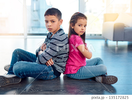 Portrait, children and sitting with arms crossed after fight, anger and backs together on floor in house. Angry, brother and sister in home living room, fighting or argument, conflict or problem. Portrait, children and sitting with arms crossed after fight, anger and backs together on floor in house. Angry, brother and sister in home living room, fighting or argument, conflict or problem. 135172825
