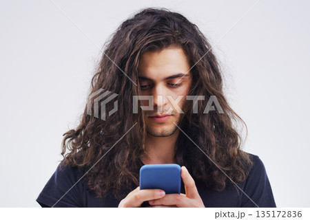 Phone, communication and face of man in studio typing for social media post, internet and online chat. Mockup, white background and male person on smartphone for website, mobile app and networking Phone, communication and face of man in studio typing for social media post, internet and online chat. Mockup, white background and male person on smartphone for website, mobile app and networking 135172836