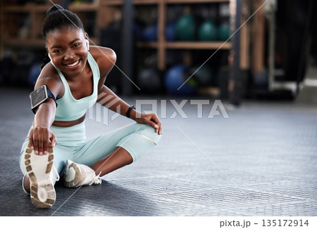 Music, portrait or black woman in gym stretching legs for workout routine or body movement for fitness. Happy, headphones or healthy girl athlete smiling in exercise training warm up for flexibility Music, portrait or black woman in gym stretching legs for workout routine or body movement for fitness. Happy, headphones or healthy girl athlete smiling in exercise training warm up for flexibility 135172914