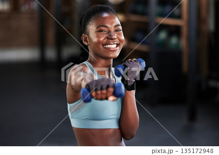 Portrait, dumbbell or happy girl boxing in training, exercise or workout for a strong powerful punch in gym. Smile, face or black woman boxer with dumbbells, weights or exercising in fitness club Portrait, dumbbell or happy girl boxing in training, exercise or workout for a strong powerful punch in gym. Smile, face or black woman boxer with dumbbells, weights or exercising in fitness club 135172948