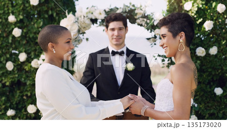 Love, holding hands and smile with lesbian couple at wedding for celebration, gay and pride. Lgbtq, spring and happiness with women at marriage event for partner commitment, care and freedom 135173020