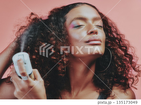 Hairspray, curly hair and beauty with woman in studio for hairstyle, self care and natural. Skincare, makeup and cosmetics with female model isolated on pink background for pride, glow and texture Hairspray, curly hair and beauty with woman in studio for hairstyle, self care and natural. Skincare, makeup and cosmetics with female model isolated on pink background for pride, glow and texture 135173049