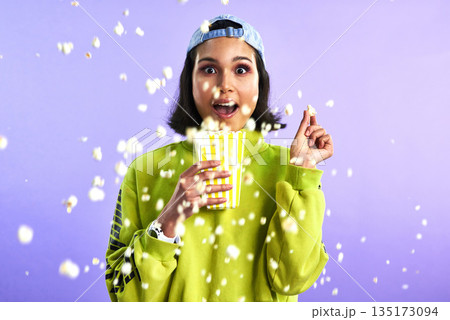 Popcorn, movie and woman surprise watching theatre or streaming service or cinema and in studio against a purple background. Video, entertainment and film or television or omg and snack on mock up 135173094