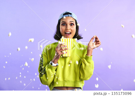 Surprise, wow and woman with popcorn for a movie or streaming service or cinema and in studio against a purple background. Video, entertainment and film or television or omg and snack on mock up Surprise, wow and woman with popcorn for a movie or streaming service or cinema and in studio against a purple background. Video, entertainment and film or television or omg and snack on mock up 135173096