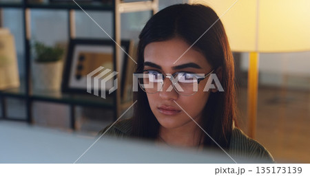 Computer, night and face with a woman editor working in her office for a journalism or news report. Focus, editing and reporting with a young journalist at work on a desktop for online content Computer, night and face with a woman editor working in her office for a journalism or news report. Focus, editing and reporting with a young journalist at work on a desktop for online content 135173139